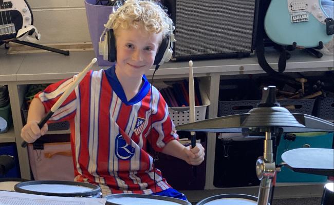 2nd grade boy on drum set