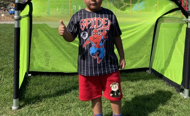 1st grade boy in front of soccer goal