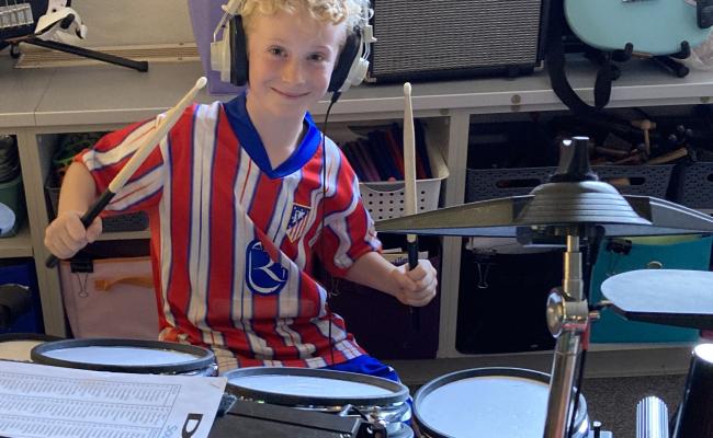 2nd grade boy on drum set