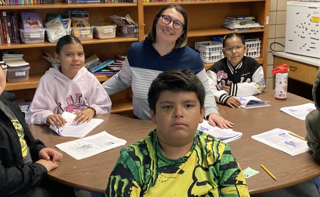 4th grade class learning with teacher