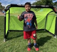 1st grade boy in front of soccer goal
