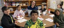 4th grade class learning with teacher