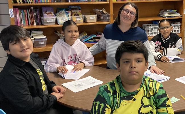 4th grade class learning with teacher